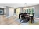 Bright dining area features modern lighting, neutral tones, and a view of the landscaped outdoors at 5370 Whispering Pine Cir, St Cloud, FL 34771