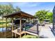 Waterfront property featuring a private boat lift with a covered dock and patio seating area at 5370 Whispering Pine Cir, St Cloud, FL 34771