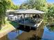 Picturesque waterfront dock with a covered gazebo, ideal for relaxation and enjoying scenic water views at 5370 Whispering Pine Cir, St Cloud, FL 34771