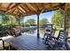 Beautiful waterfront outdoor space with a covered dock, swing, and canal views at 5370 Whispering Pine Cir, St Cloud, FL 34771