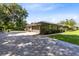 Charming single-story home featuring a well-maintained lawn, stone accents, and a spacious driveway at 5370 Whispering Pine Cir, St Cloud, FL 34771
