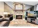 Close up of a stone fireplace with a wooden mantle and an animal art piece hanging above it at 5370 Whispering Pine Cir, St Cloud, FL 34771