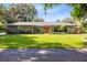 Charming single-story home with a well-manicured lawn and a stone facade at 5370 Whispering Pine Cir, St Cloud, FL 34771