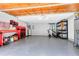 Spacious garage featuring epoxy floors, storage racks, and ample room for vehicles and projects at 5370 Whispering Pine Cir, St Cloud, FL 34771