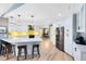 Spacious kitchen with a breakfast bar, white cabinetry, and stainless steel appliances at 5370 Whispering Pine Cir, St Cloud, FL 34771