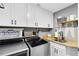 Well-organized laundry room with modern appliances, ample storage, and a functional sink area at 5370 Whispering Pine Cir, St Cloud, FL 34771