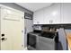 Functional laundry room with white cabinets, modern washer and dryer, and ample storage space at 5370 Whispering Pine Cir, St Cloud, FL 34771