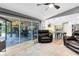 Bright living room with an open layout, seamlessly connecting to an outdoor seating area and modern kitchen at 5370 Whispering Pine Cir, St Cloud, FL 34771