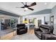 Open-concept living room featuring a kitchen and outdoor views, creating a bright and spacious atmosphere at 5370 Whispering Pine Cir, St Cloud, FL 34771