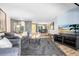 Living room with view to the dining room and outdoor seating area providing an open, connected living experience at 5370 Whispering Pine Cir, St Cloud, FL 34771