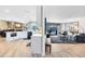 Open concept kitchen and living spaces featuring modern appliances and seamless access to the backyard and lounge area at 5370 Whispering Pine Cir, St Cloud, FL 34771