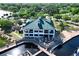 Two-story marina building with outdoor dining, overlooking boat docks on the water at 5370 Whispering Pine Cir, St Cloud, FL 34771
