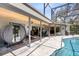 Outdoor pool area with a covered patio, lounge chairs, and a sauna-like feature. Great backyard! at 5370 Whispering Pine Cir, St Cloud, FL 34771
