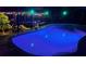 Night view of pool featuring underwater lighting and covered seating area with festive decorations at 5370 Whispering Pine Cir, St Cloud, FL 34771