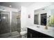 Clean bathroom with a glass-enclosed shower, double sink vanity, and modern fixtures at 818 Kapi Dr, Groveland, FL 34736
