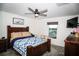 Cozy bedroom with carpet flooring, ceiling fan, window with view, and comfy quilt at 818 Kapi Dr, Groveland, FL 34736