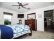 Comfortable bedroom featuring soft carpet, dark wood furniture, and neutral decor at 818 Kapi Dr, Groveland, FL 34736