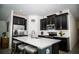 Updated kitchen with stainless steel appliances, a large center island, and sleek dark cabinetry at 818 Kapi Dr, Groveland, FL 34736