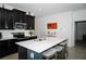 Well-equipped kitchen with dark cabinets, stainless steel appliances, and a spacious island with seating at 818 Kapi Dr, Groveland, FL 34736
