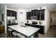 Modern kitchen featuring dark cabinets, stainless steel appliances, and a center island with seating at 818 Kapi Dr, Groveland, FL 34736