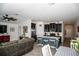Modern kitchen featuring a kitchen island, with barstools, stainless steel appliances, and an open layout at 818 Kapi Dr, Groveland, FL 34736