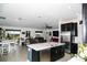 Modern kitchen featuring an island with barstool seating, stainless steel appliances and open to living room at 818 Kapi Dr, Groveland, FL 34736
