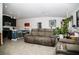 Open-concept living room with a kitchen island, seating area, and neutral decor at 818 Kapi Dr, Groveland, FL 34736