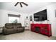 Relaxing living room featuring a gray reclining sofa, and entertainment center with a fireplace at 818 Kapi Dr, Groveland, FL 34736