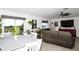 Bright living room with tile flooring, comfortable seating, and natural light streaming in through large windows at 818 Kapi Dr, Groveland, FL 34736