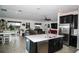 Open concept living room with a large kitchen island, dining area, and comfortable seating area at 818 Kapi Dr, Groveland, FL 34736