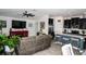 Inviting open-concept living room and kitchen, stainless steel appliances, comfortable seating, and tile floors at 818 Kapi Dr, Groveland, FL 34736