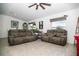 Inviting living room featuring two comfortable sofas, neutral tones, and a ceiling fan at 818 Kapi Dr, Groveland, FL 34736
