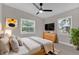 Cozy bedroom with a large window, ceiling fan and stylish decor at 900 Citrus St, Orlando, FL 32805
