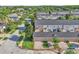 View of townhome, garages, and surrounding street at 9189 Camden Gardens St, Orlando, FL 32827
