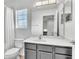 Bathroom boasts a large mirror, a grey vanity, and a window letting in natural light at 9189 Camden Gardens St, Orlando, FL 32827