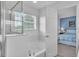 Bright bathroom featuring a glass shower and soaking tub with a window overlooking the yard at 9189 Camden Gardens St, Orlando, FL 32827