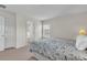 Bedroom featuring floral bedding and a window with a door leading into the bathroom at 9189 Camden Gardens St, Orlando, FL 32827