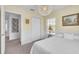 Bright bedroom features large window, white interior, and access to the closet and hallway at 9189 Camden Gardens St, Orlando, FL 32827