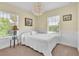 Bright bedroom with large window and white interior, enhanced by an elegant chandelier at 9189 Camden Gardens St, Orlando, FL 32827