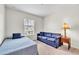 Cozy bedroom showcases a twin bed and sofa, offering a comfortable and inviting space at 9189 Camden Gardens St, Orlando, FL 32827