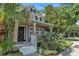 Lovely home exterior with a quaint front porch, black front door, and lush greenery at 9189 Camden Gardens St, Orlando, FL 32827
