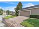 Attached two-car garage with brick-paved driveway at 9189 Camden Gardens St, Orlando, FL 32827