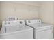 Laundry room equipped with a washer and dryer, ready for efficient and convenient laundry tasks at 9189 Camden Gardens St, Orlando, FL 32827
