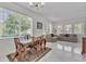 Open-concept room boasts great light, dining set, and comfortable seating at 9189 Camden Gardens St, Orlando, FL 32827