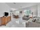 Bright living area with large windows, sleek marble floors, and neutral furnishings at 9189 Camden Gardens St, Orlando, FL 32827