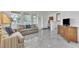 Sun-filled living area with marble floors and comfortable seating at 9189 Camden Gardens St, Orlando, FL 32827