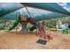 Community playground with shade covering and updated equipment at 9189 Camden Gardens St, Orlando, FL 32827