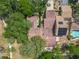 Aerial view of home showing the roof, backyard pool, solar panels, and surrounding greenery at 103 Red Cedar Dr, Longwood, FL 32779