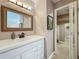 Bathroom with a large mirror above a white vanity and a peak into the walk in closet at 103 Red Cedar Dr, Longwood, FL 32779