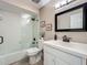 Clean bathroom featuring a shower with glass door, white tiled walls, and sleek fixtures at 103 Red Cedar Dr, Longwood, FL 32779